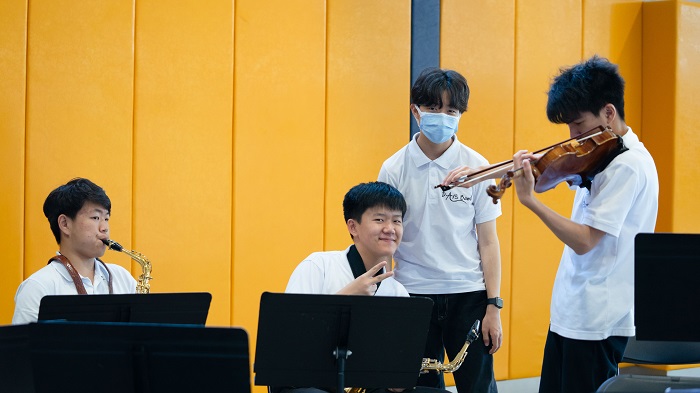 Raymond with friends play in the orchestra