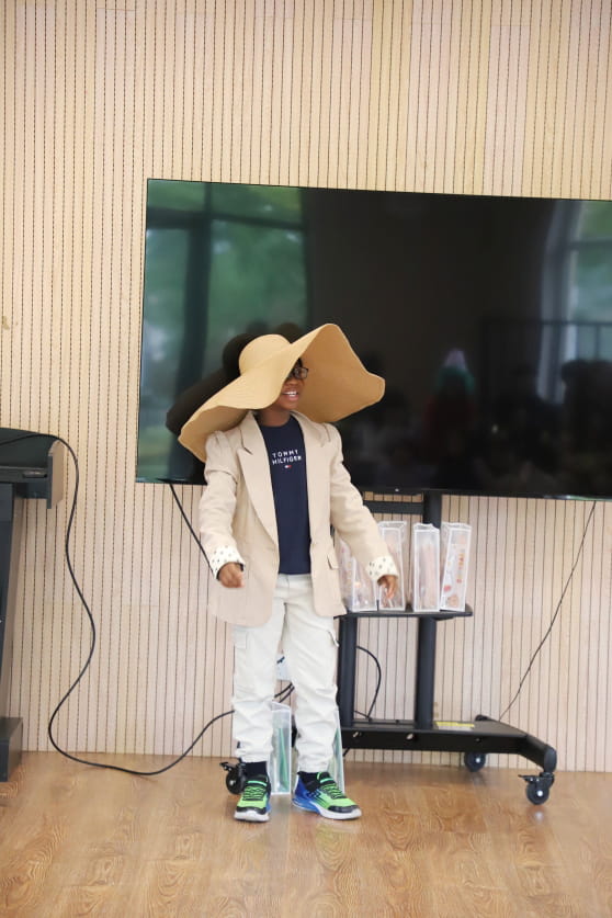 boy wearing a really big hat