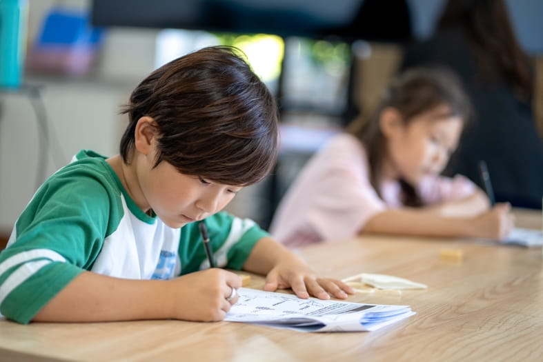 elementary school student writing something