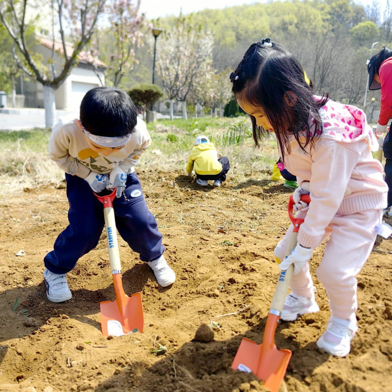 little kids digging in the garden
