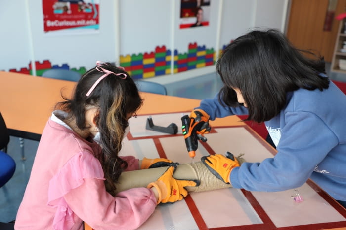 two girls building a cat tree