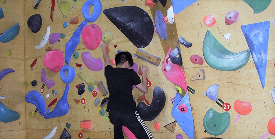 Student climbing a wall