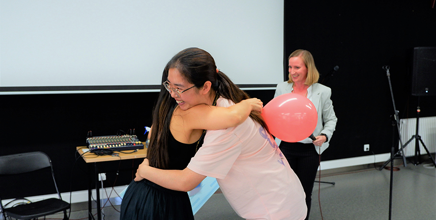 Two teachers hugging