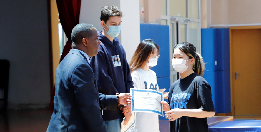 Principal giving a certificate to a student