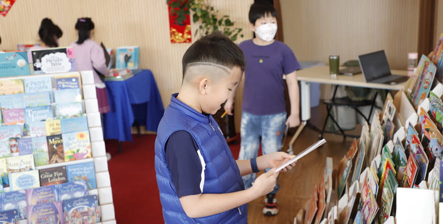 Boy reading a book cover