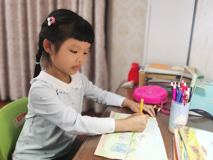 A girl drawing a picture about peace